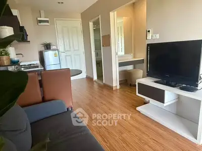 Modern living room with sleek furniture and open kitchen layout