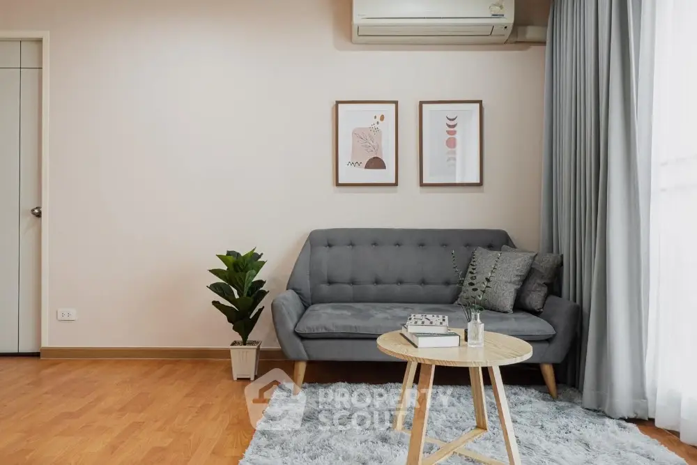 Modern living room with stylish sofa, wooden floor, and elegant decor