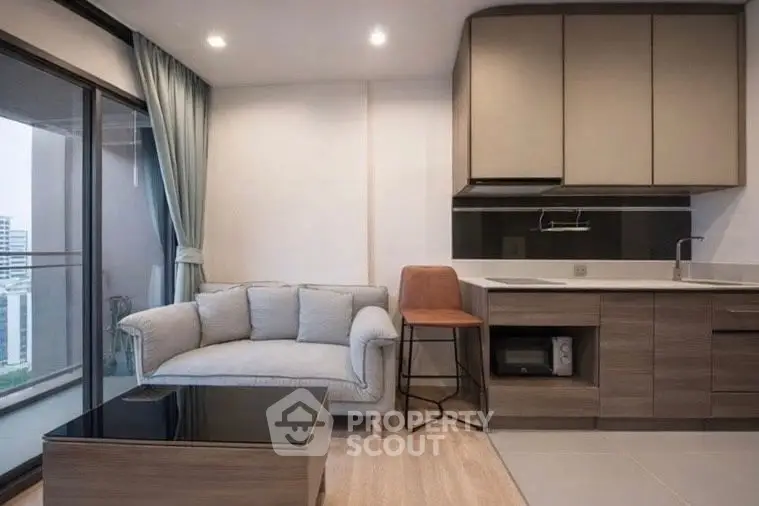 Modern living room with sleek kitchen and city view balcony