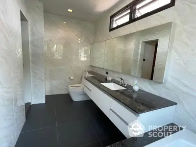 Luxurious modern bathroom with marble walls and sleek fixtures