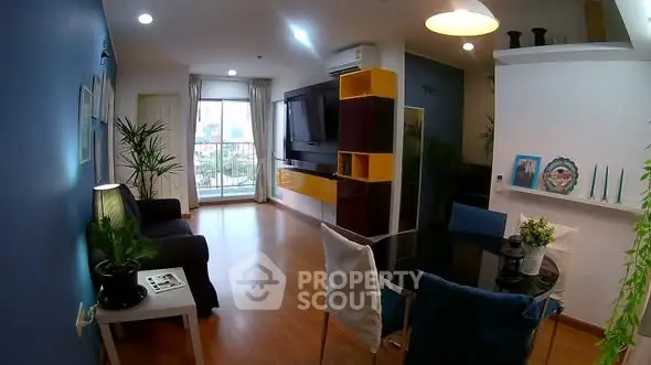 Stylish living room with modern decor and city view, featuring vibrant colors and sleek furniture.