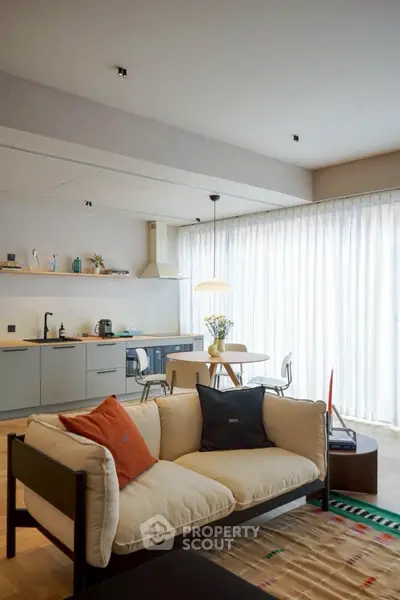 Modern open-plan living room with stylish kitchen and cozy seating area.