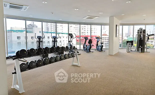 Spacious modern gym with city views and state-of-the-art equipment.