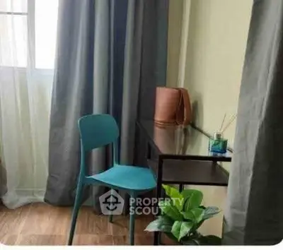 Cozy study nook with modern chair and desk by a window, perfect for productivity.