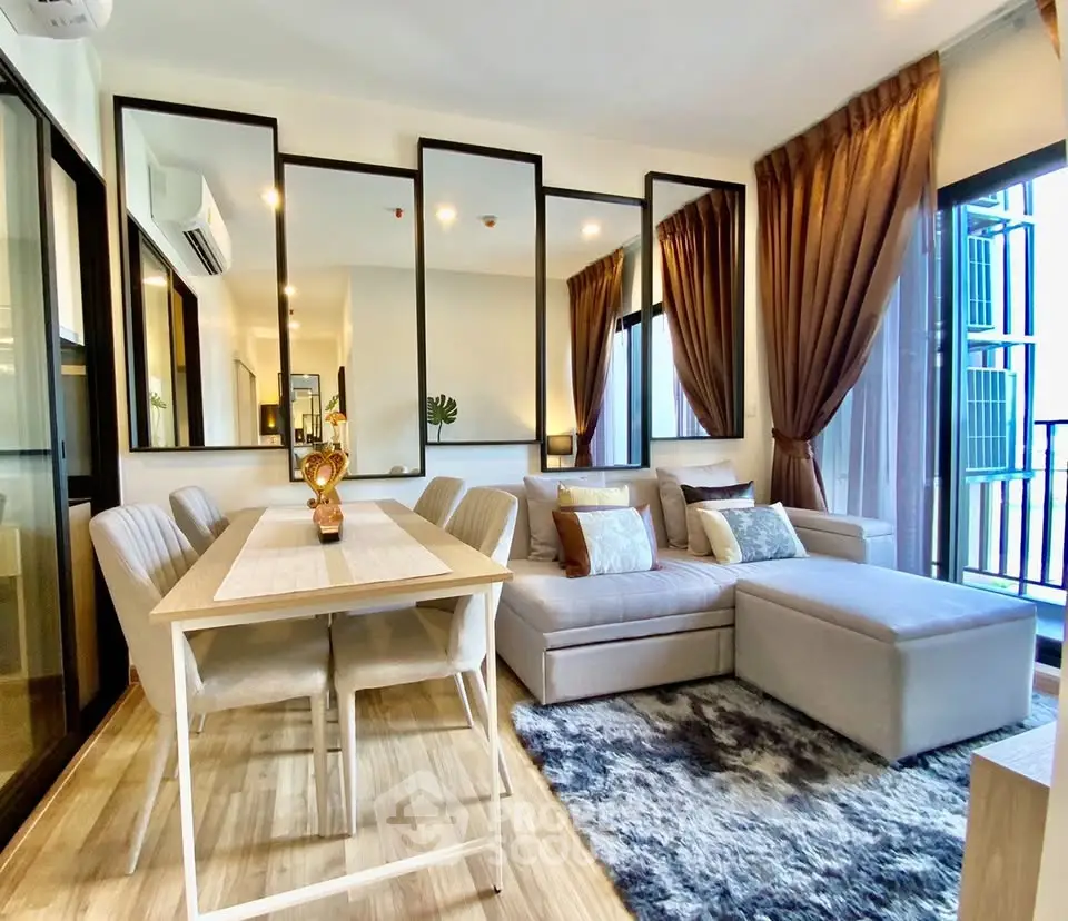 Modern living room with elegant decor, large windows, and cozy seating area in a stylish apartment.