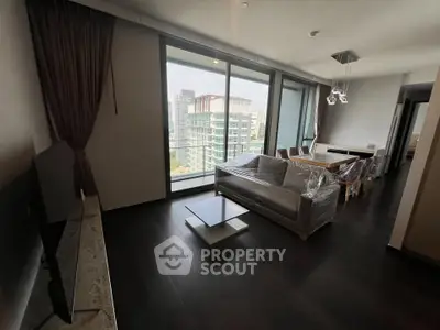 Modern living room with floor-to-ceiling windows and city view, featuring sleek furniture and elegant dining area.