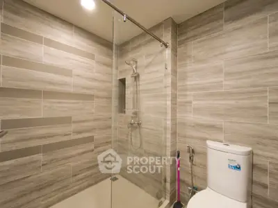 Modern bathroom with glass shower and sleek tile design