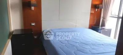 Spacious bedroom with modern design and large window for natural light.