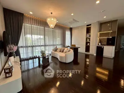 Luxurious living room with elegant chandelier and dark wood flooring
