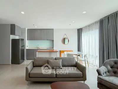 Modern open-plan living room with sleek kitchen and stylish furniture