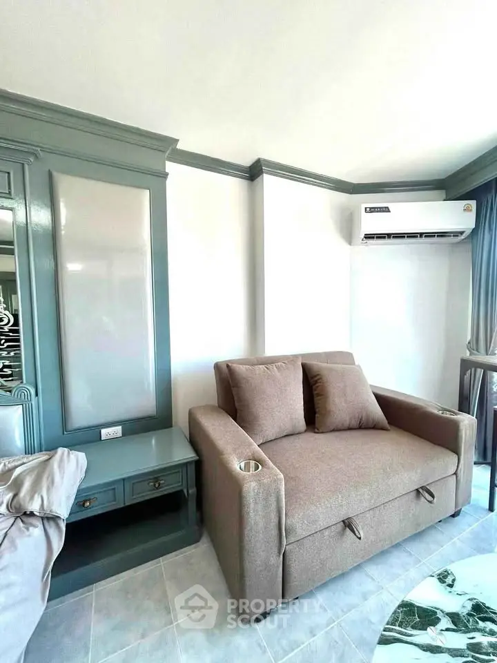 Chic living room with modern sofa and air conditioning, perfect for cozy relaxation.