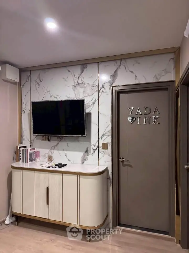 Stylish modern living room with marble accent wall and sleek TV setup