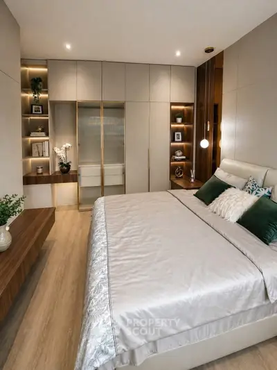 Luxurious modern bedroom with elegant decor and built-in storage solutions.