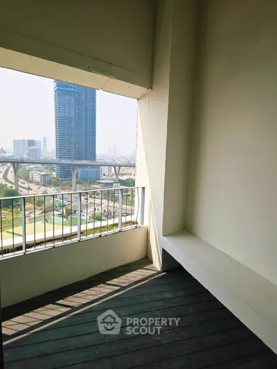 Spacious balcony with stunning city view, perfect for relaxation and enjoying urban skyline.
