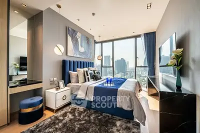 Luxurious modern bedroom with city view, elegant decor, and plush furnishings in high-rise apartment.