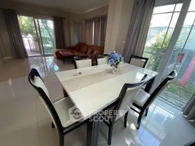 Spacious living room with elegant dining area and large windows for natural light.