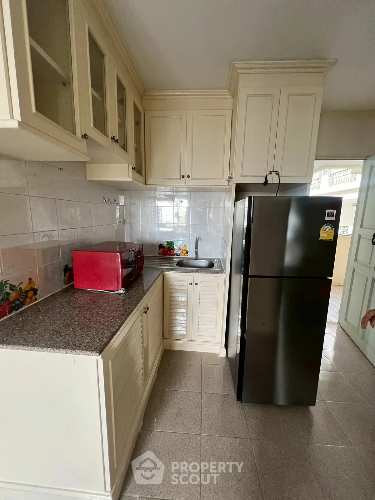 Charming kitchen with modern appliances and classic cabinetry, perfect for culinary enthusiasts.