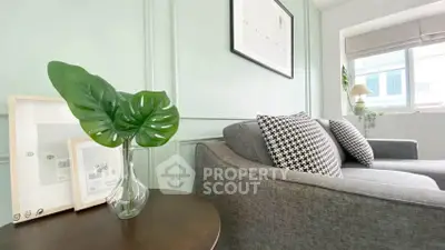 Stylish living room with modern gray sofa and chic decor