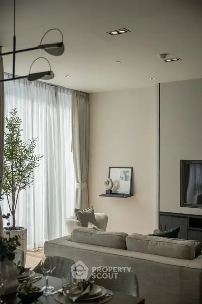Elegant living room with modern decor and large windows for natural light