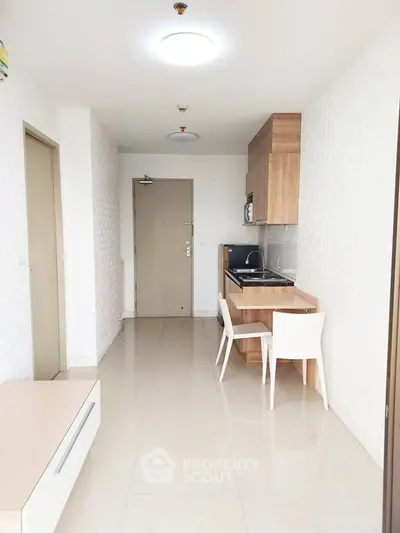Modern minimalist kitchen with sleek design and compact dining area