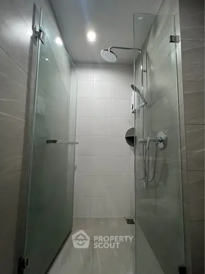 Modern bathroom with glass shower doors and sleek fixtures