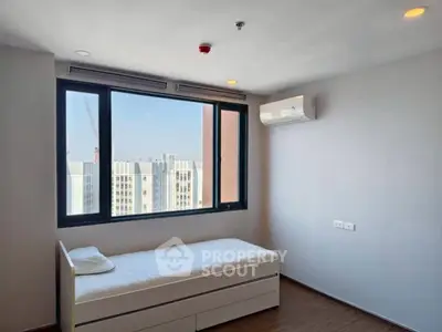 Modern minimalist bedroom with city view and air conditioning in high-rise apartment.