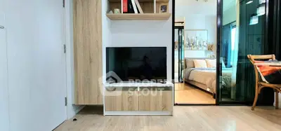 Modern apartment interior with TV and cozy bedroom view