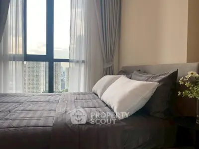 Modern bedroom with large window and elegant gray bedding