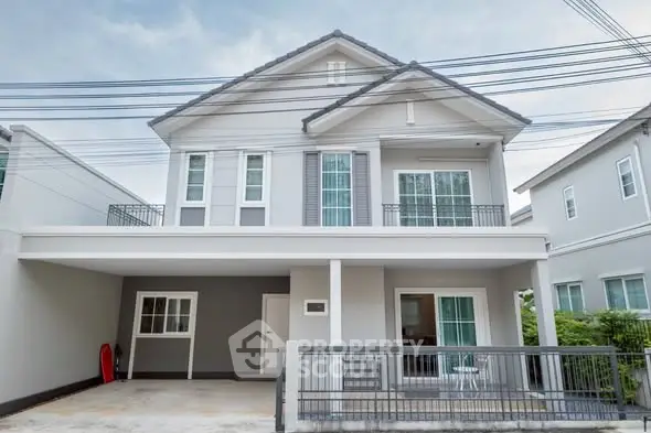 Modern two-story house with a spacious driveway and contemporary design.