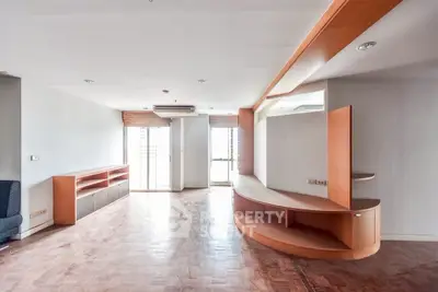 Spacious living room with modern built-in wooden shelves and natural light
