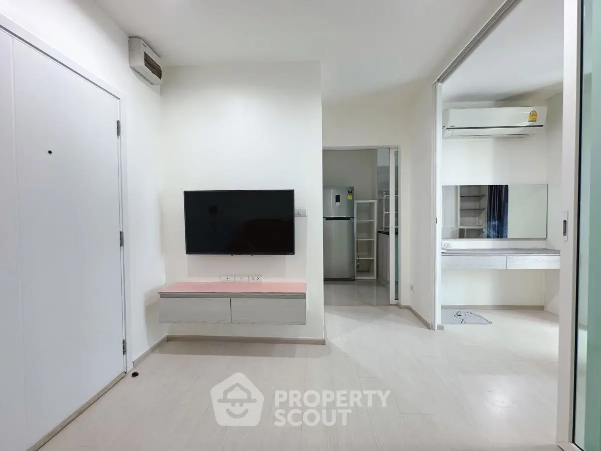 Modern apartment interior with sleek design and wall-mounted TV