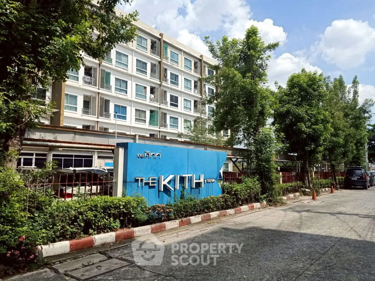 Modern apartment building with lush greenery and clear blue sky