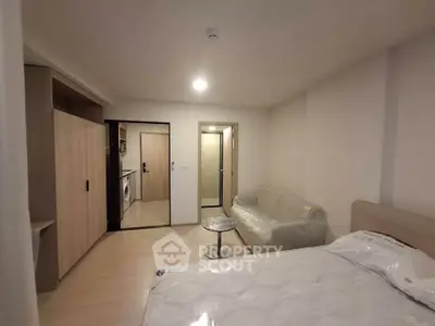 Modern studio apartment with cozy living area and compact kitchen