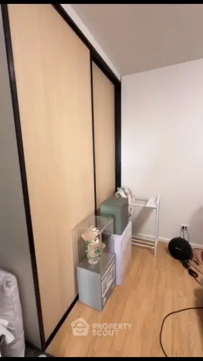 Spacious room with sliding closet doors and wooden flooring, ideal for storage solutions.