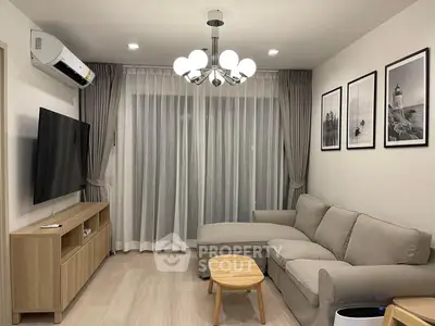 Modern living room with stylish decor, cozy sofa, and elegant lighting in a contemporary apartment.