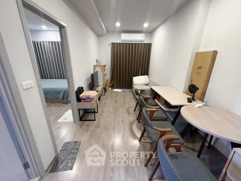 Modern apartment interior with open layout and stylish furniture, featuring a cozy bedroom and living area.