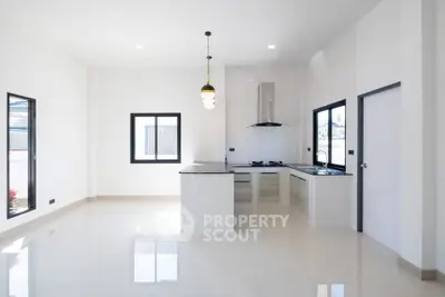 Modern minimalist kitchen with sleek design and ample natural light