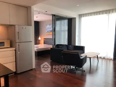 Modern open-plan living room with kitchen and bedroom in a stylish apartment