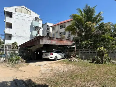 Charming residential property with carport and lush greenery, perfect for serene living.