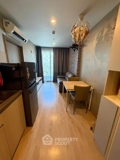 Modern living room with stylish decor and open layout, featuring a cozy sofa and dining area.