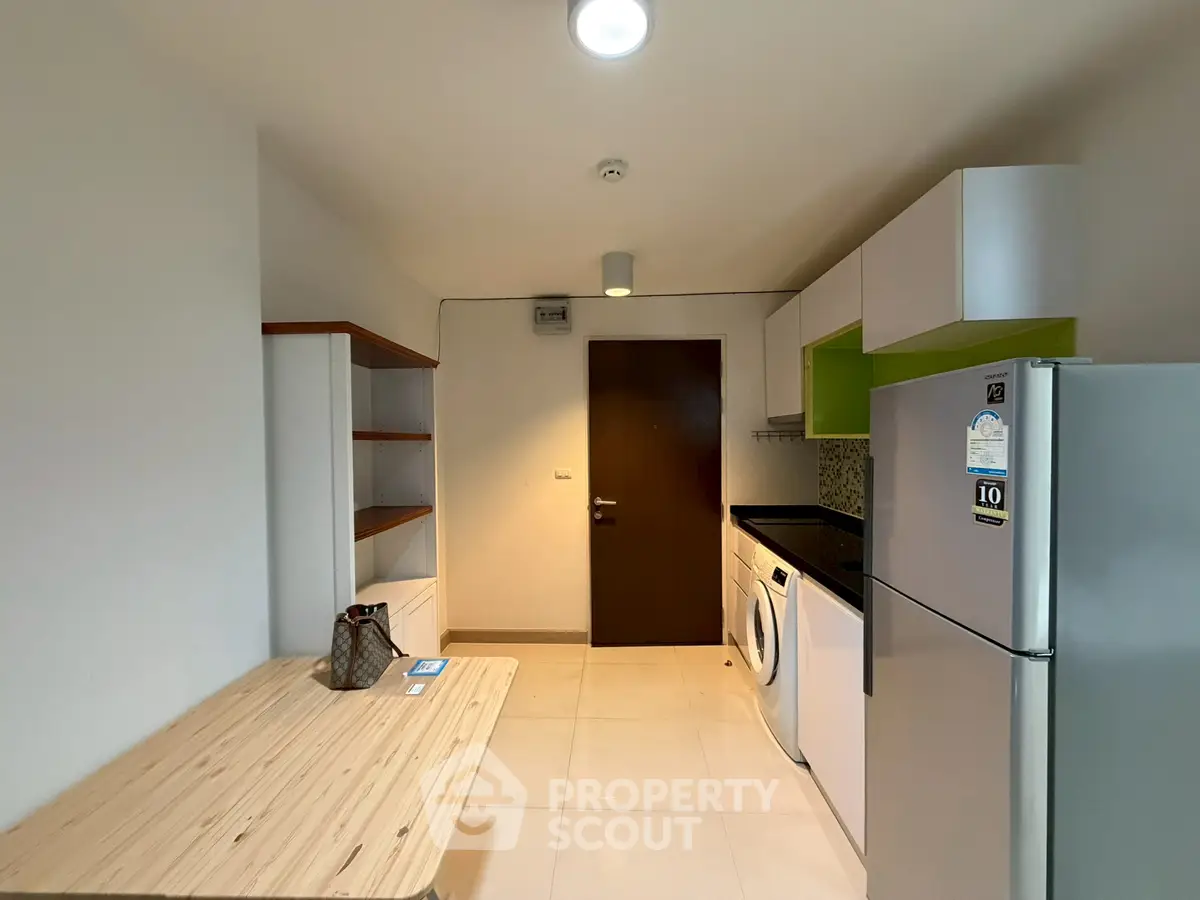 Modern kitchen with sleek appliances and ample storage space