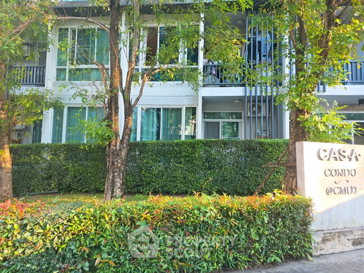 Modern condo exterior with lush greenery and stylish facade