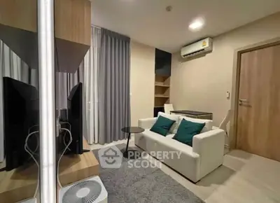 Modern living room with cozy sofa, air conditioning, and stylish decor in a contemporary apartment.