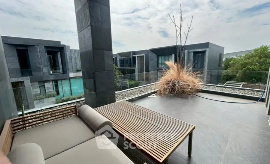 Luxurious modern balcony with sleek design and stunning view of contemporary architecture.