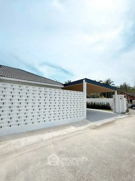 Modern exterior with white brick wall and sleek carport design
