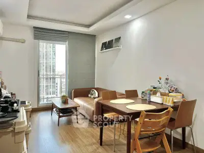 Modern living room with dining area and balcony view in stylish apartment