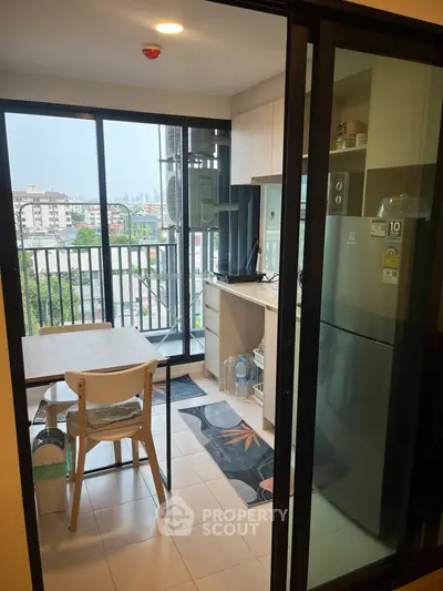 Modern kitchen with balcony view in high-rise apartment