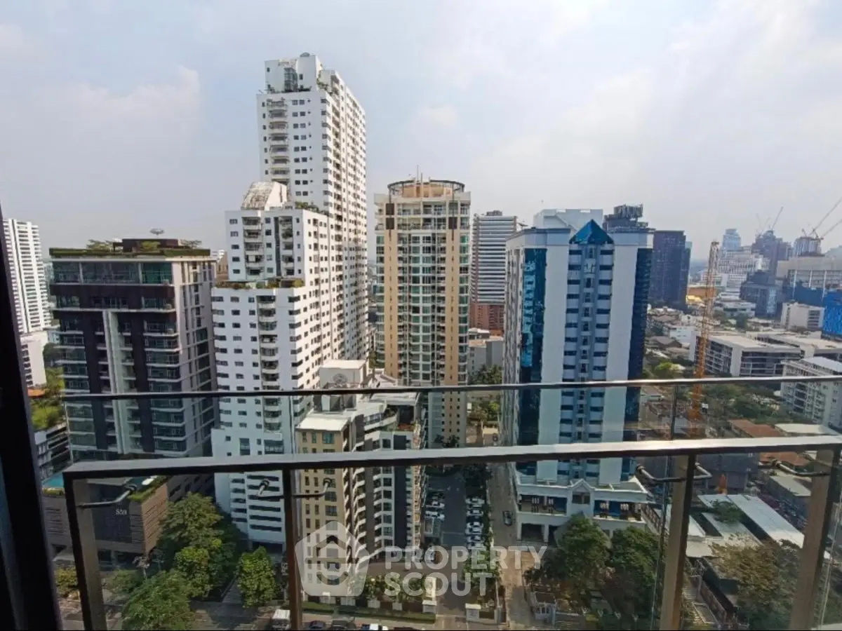Stunning cityscape view from a high-rise balcony overlooking modern skyscrapers and urban skyline.