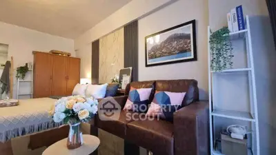 Stylish living room with modern decor and cozy seating in a contemporary apartment.