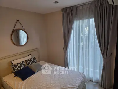 Cozy bedroom with elegant curtains and stylish decor, perfect for relaxation and comfort.